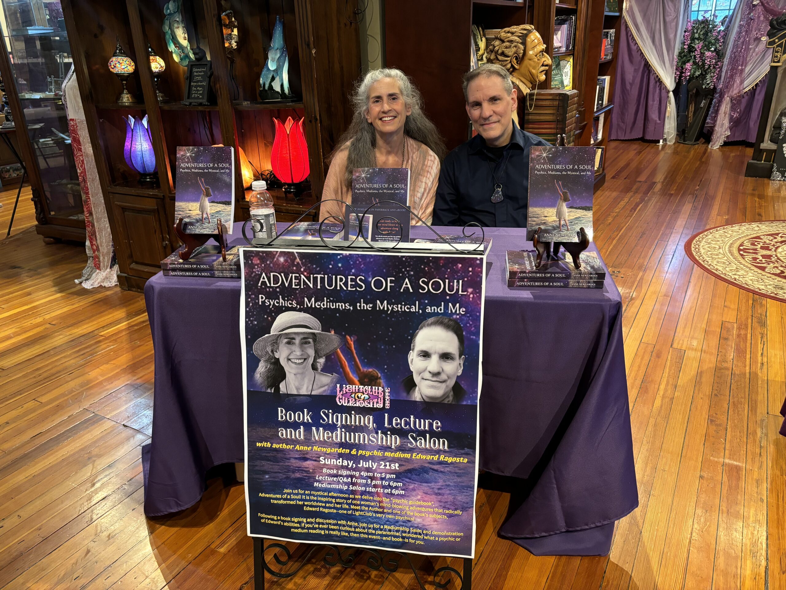 Anne Newgarden and Edward Ragosta behind an Adventures of a Soul signing table at LightClub Curiosity Shoppe