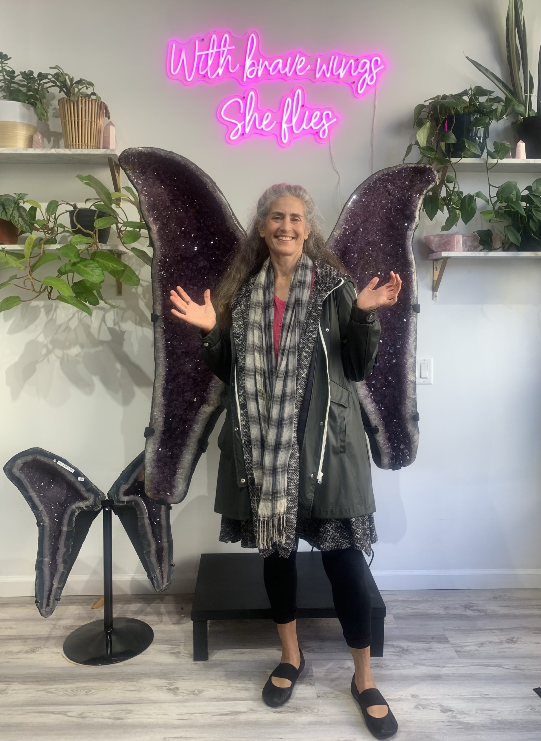 Anne Newgarden smiling between amethyst wings at Freedom Rocks in Asbury Park