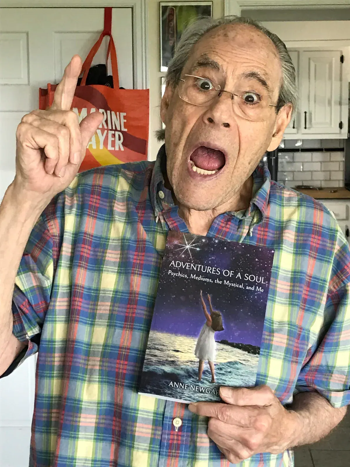Robert Klein holding a copy of Adventures of a Soul