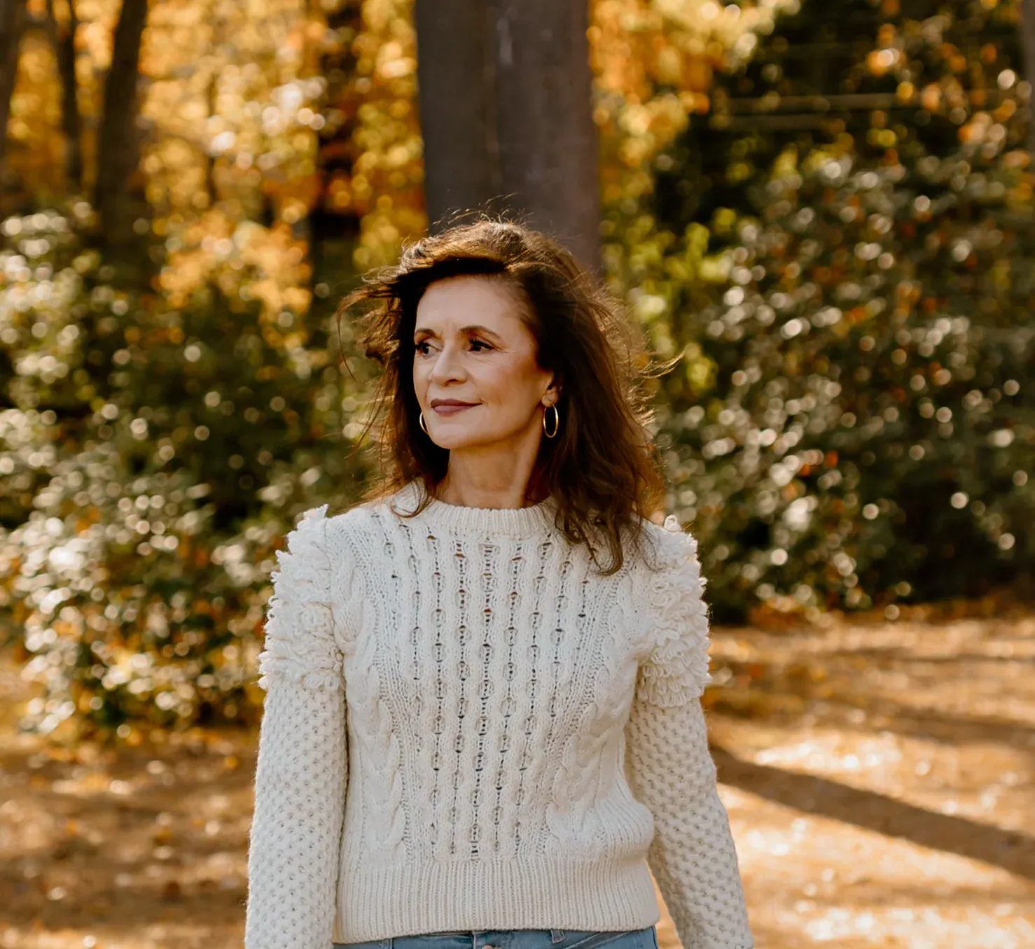 Psychic medium Jennifer Hicks standing on a wooded path