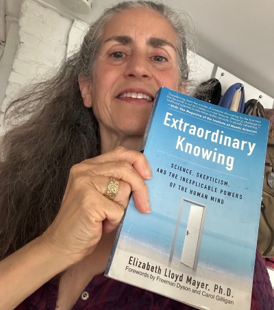 Anne Newgarden holding Extraordinary Knowing by Elizabeth Lloyd Mayer