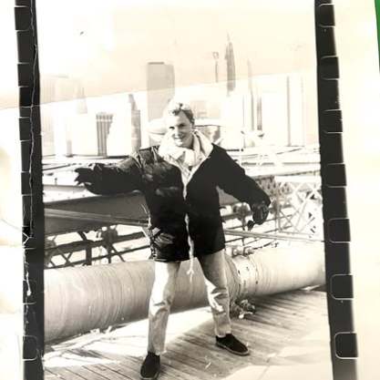 A young man posing in a black-and-white photograph
