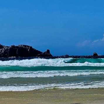 Waves breaking along a rocky shore in Brittany