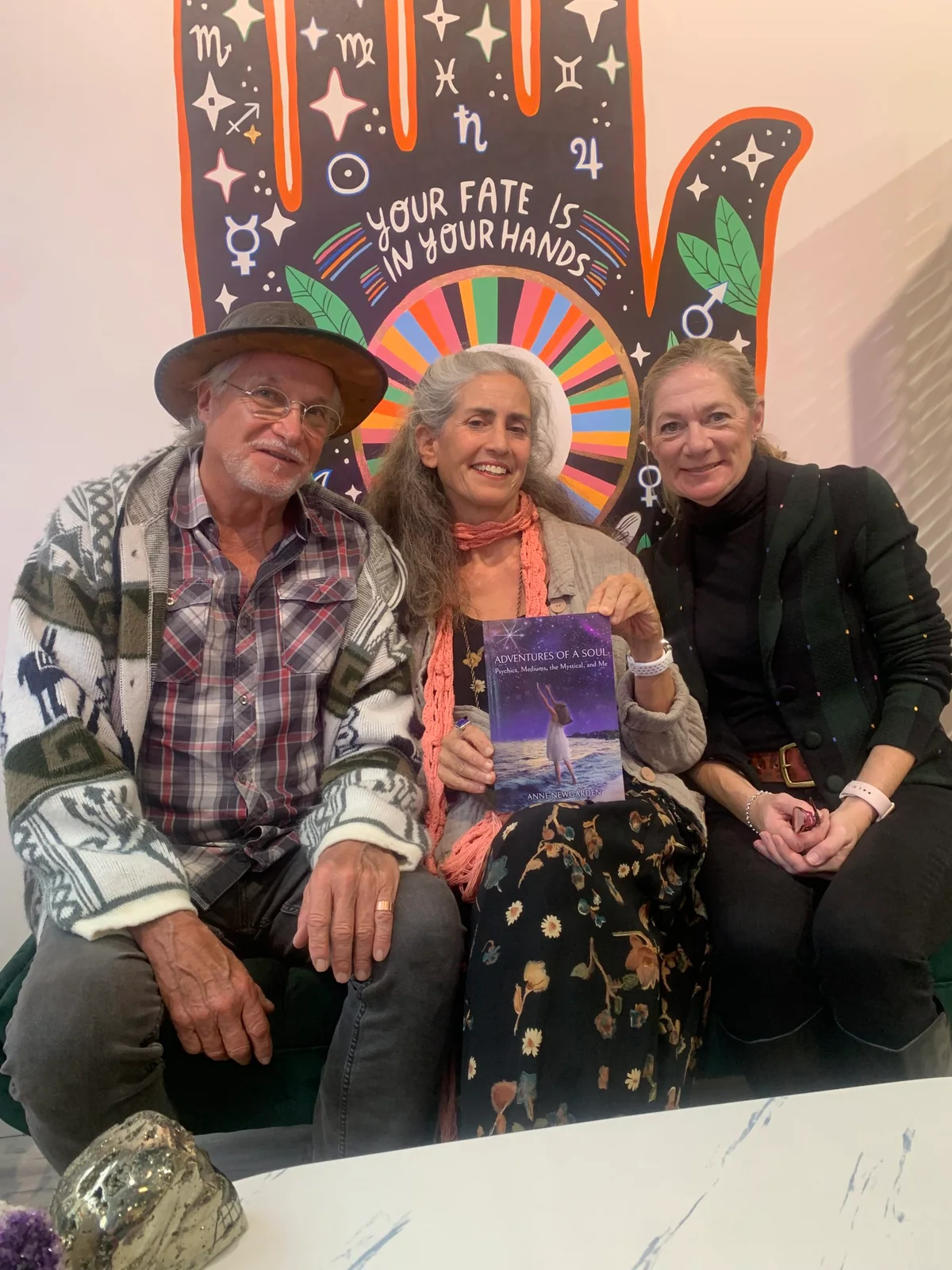 Anne Newgarden seated with two visitors at Freedom Rocks