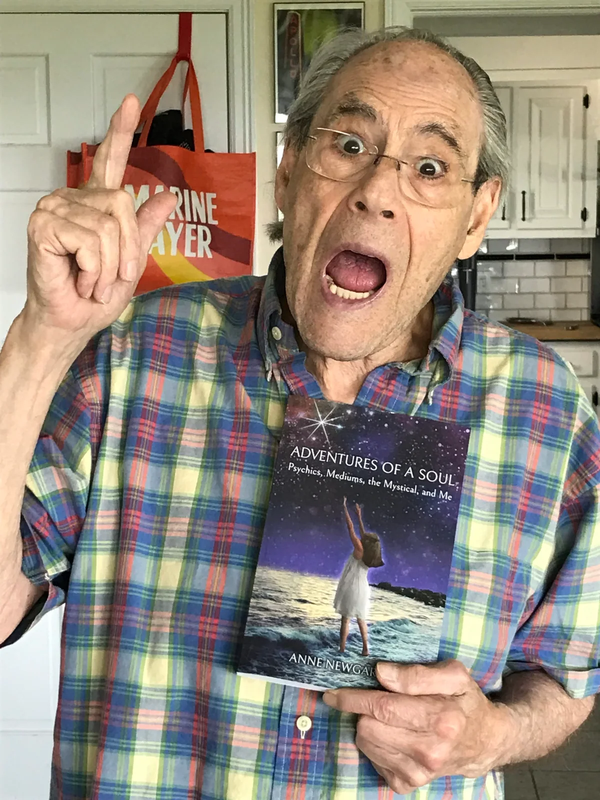 Robert Klein holding a copy of Adventures of a Soul
