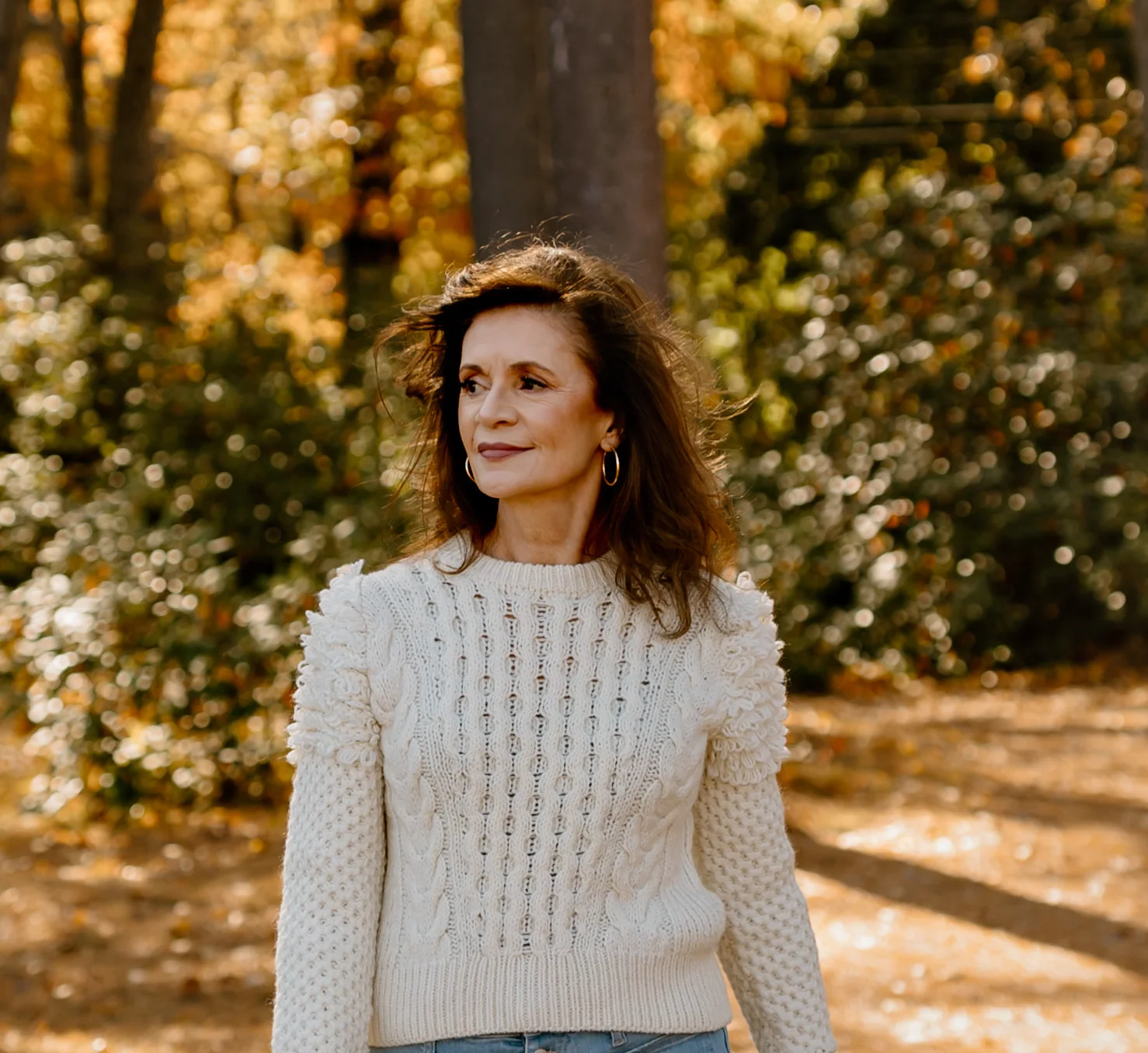 Psychic medium Jennifer Hicks standing on a wooded path